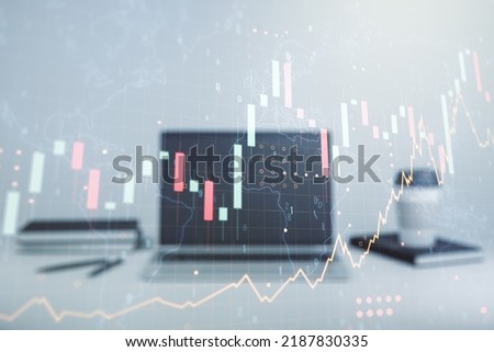 Multi exposure of abstract creative financial graph with world map on modern laptop background, forex and investment concept
