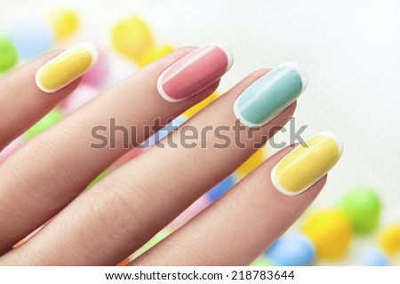 Manicure on an oval shaped nails in pastel colored tones Royalty-Free Stock Photo #218783644