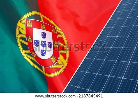 Solar panels against flag Portugal background. Solar battery generates a pure electricity. Concept of sustainable resources and renewable energy in Portugal