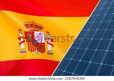Solar panels against flag Spain background. Solar battery generates a pure electricity. Concept of sustainable resources and renewable energy in Spain
