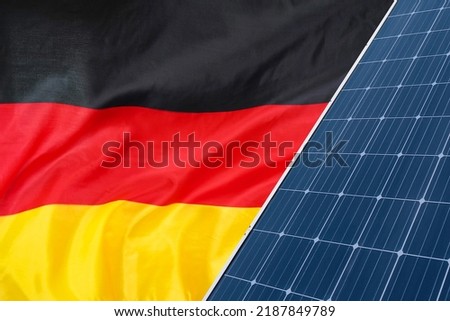 Solar panels against flag Germany background. Solar battery generates a pure electricity. Concept of sustainable resources and renewable energy in Germany