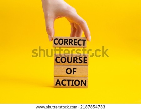 Correct course of action symbol. Concept words Correct course of action on wooden blocks. Beautiful yellow background. Businessman hand. Business and Correct course of action concept. Copy space.