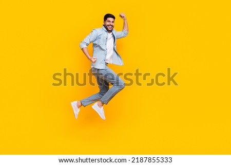 Full body photo of attractive hispanic young guy celebrate job promotion wear stylish jeans clothes isolated on yellow color background Royalty-Free Stock Photo #2187855333