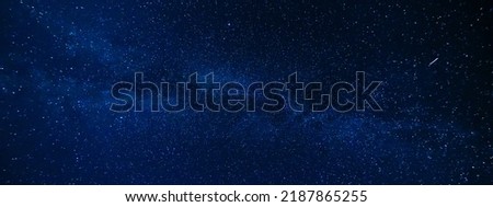 Panorama of the night starry sky on the background of the Milky Way with many colorful shining stars