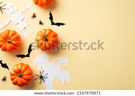 Halloween decorations concept. Top view photo of pumpkins spiders ghost skeleton and bats silhouettes on isolated beige background with empty space
