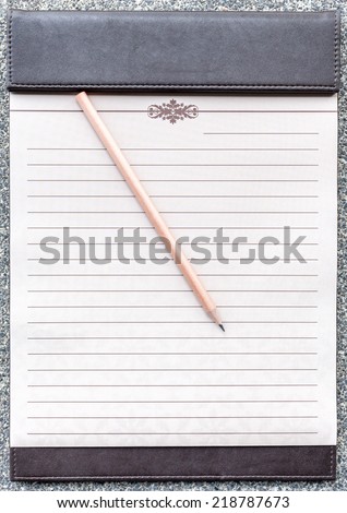 Blank notepad with pencil on the brown clipboard, for memorandum in meeting room.