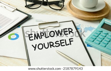 Text Empower yourself on white paper on laptop computer, business concept.