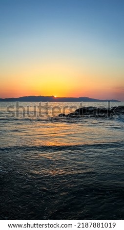 Sunset on the seashore. Sea waves at sunset. Photo