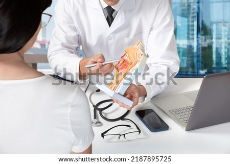 Doctor explaining the anatomy of the mucous membranes of the throat and nose to the patient in the office. Royalty-Free Stock Photo #2187895725