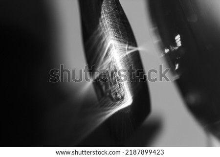 Glass bottle cast beautiful shadow and caustic effect as light passes through a glass. Black and white photo. Abstract background Royalty-Free Stock Photo #2187899423