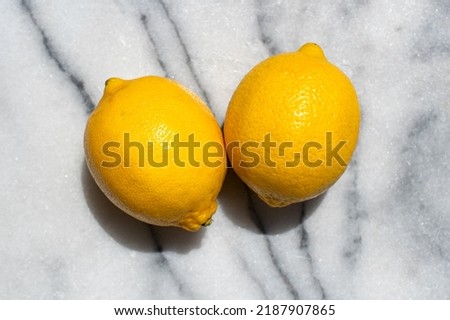 Two fresh lemons on marble