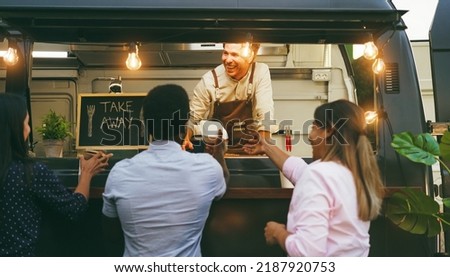 Multiracial people ordering food at counter in food truck outdoor - Soft focus on chef man face Royalty-Free Stock Photo #2187920753