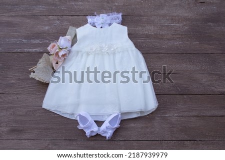 Picture of a little girl's dress with her accessories for her christening and party

