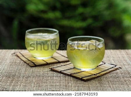 Cold Japanese green tea placed where you can see the garden. Japanese summer drink. Royalty-Free Stock Photo #2187943193