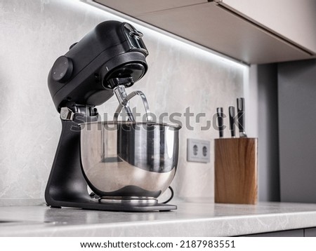 Planetary mixer, whisk and bowl close, kitchen helper Royalty-Free Stock Photo #2187983551