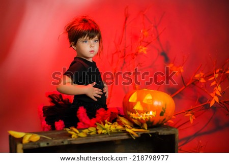 beautiful girl in witch costume. pumpkin on Halloween