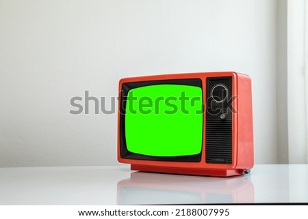 Red retro old TV cut green screen in a white room.