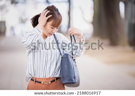 A Japanese woman who is in a hurry to forget something and is likely to be late Royalty-Free Stock Photo #2188016917