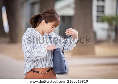 A Japanese woman who is in a hurry to forget something and is likely to be late Royalty-Free Stock Photo #2188016919