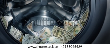 Money laundering. Many dollar banknotes in washing machine, banner design Royalty-Free Stock Photo #2188046429
