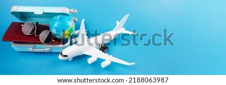 travel and tourism banner, trip insurance, online tours, international flights, plane, suitcase for luggage, sunglasses on a blue background