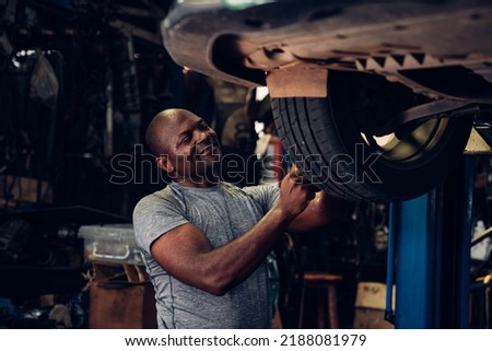 Auto mechanic are using the wrench to repair and maintenance auto engine is problems at car repair shop.