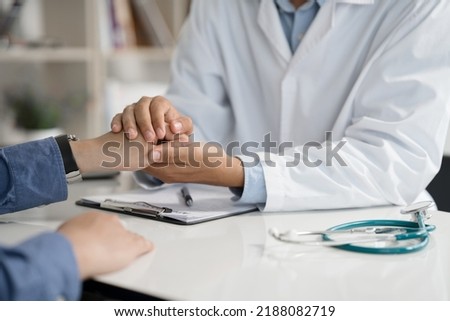 Doctor or psychiatrist shakes hands encouragement the patient and care having a consultation on diagnostic examination on male disease or mental illness in a clinic or hospital mental health service  Royalty-Free Stock Photo #2188082719