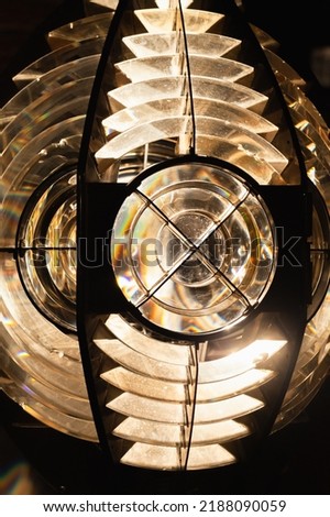 Bright lighthouse lamp with a Fresnel lens. Close up vertical photo. It is a type of composite compact lens developed by the French physicist Augustin-Jean Fresnel for use in lighthouses