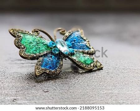 Beautiful decorative brooch in the form of a butterfly with enamel close up Royalty-Free Stock Photo #2188095153