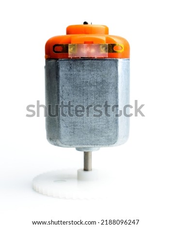 Direct current electric motor with white gear attached to it shaft on a white background. Macro photo. Background picture.