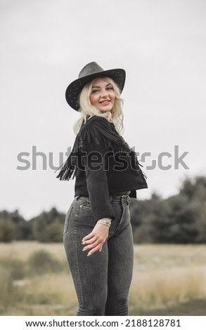 Woman in American country style,  suede leather boho jacket and cowboy hat at nature