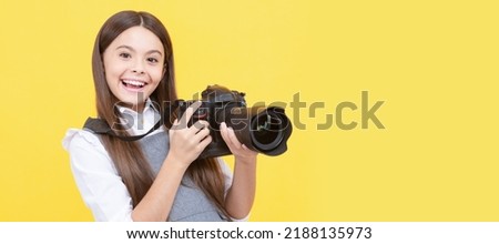 happy teen girl photographer use digital photo camera, photographing. Child photographer with camera, horizontal poster, banner with copy space. Royalty-Free Stock Photo #2188135973