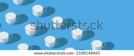Banner with milk in a glass pattern on a colored background, dairy diet concept . High quality photo