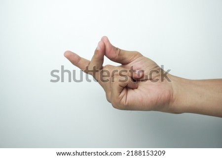 studio shot of an unrecognizable man snapping his fingers against a white background