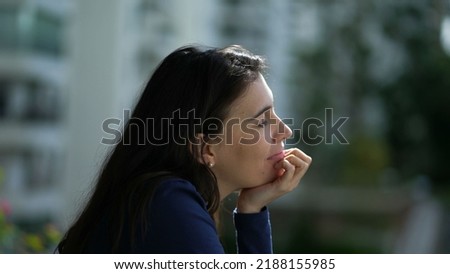 Pensive happy woman daydreaming. Thoughtful person standing at home balcony smiling Royalty-Free Stock Photo #2188155985
