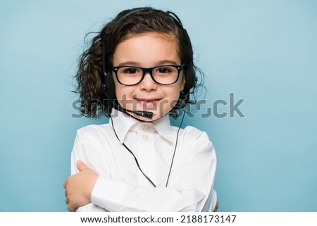 Portrait of a caucasian boy wearing a headset and playing sales representative or customer support on a call center