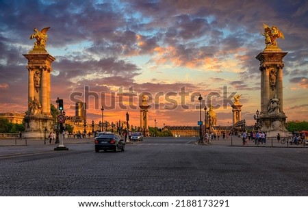 Pont Alexandre III bridge over river Seine and Hotel des Invalides on background at sunset in Paris, France.  Cityscape of Paris. Architecture and landmarks of Paris.