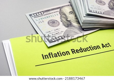 The Inflation Reduction Act of 2022 and cash on it. Royalty-Free Stock Photo #2188173467