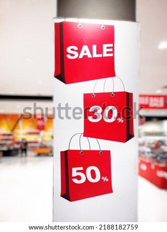 50, 30​ percent discount red banner on display in a department store.​Discounts on Chinese New Year's Day.Sign of sale shopping.