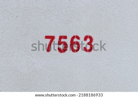 Red Number 7563 on the white wall. Spray paint.
