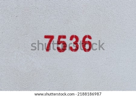 Red Number 7536 on the white wall. Spray paint.
