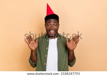 Photo of positive crazy guy wear cone headwear impressed incredible present isolated on pastel color background