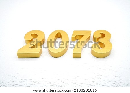    Number 2073 is made of gold painted teak, 1 cm thick, laid on a white painted aerated brick floor, visualized in 3D.                               