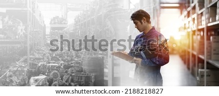 Asian male mechanic worker working at old motor automotive spare parts warehouse. Male engineer checking old engine, motor, machine at the garage industry factory. Double exposure Royalty-Free Stock Photo #2188218827