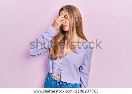 Beautiful hispanic woman wearing casual shirt tired rubbing nose and eyes feeling fatigue and headache. stress and frustration concept. 