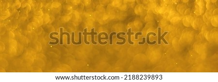 Golden sparkling glitter bokeh background, texture. Holiday lights. Abstract defocused header. Wide screen wallpaper. Panoramic web banner with copy space for design