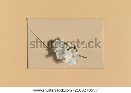 Envelope on a beige background. Minimalistic flat lay.