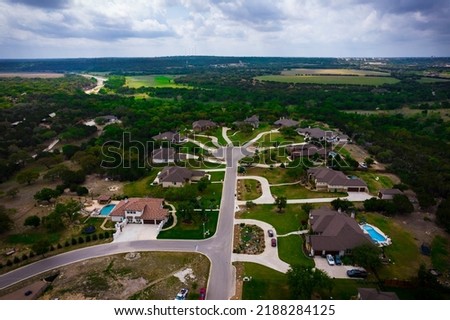 high above green landscape and Luxury Houses and homes on green hilltop in suburb real estate community in very high demand outside of Austin , Texas , USA 