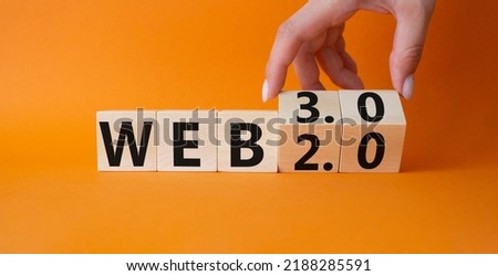 Web 3.0 vs Web 2.0 symbol. Hand turns cubes and changes the word web 3.0 to web 2.0. Beautiful orange background. Businessman hand. Business concept. Copy space Royalty-Free Stock Photo #2188285591