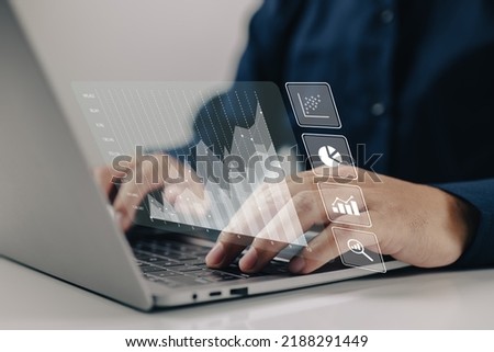 The concept of analytics for large amounts of data and business intelligence. Financial charts are displayed on a screen that is simulated. Royalty-Free Stock Photo #2188291449